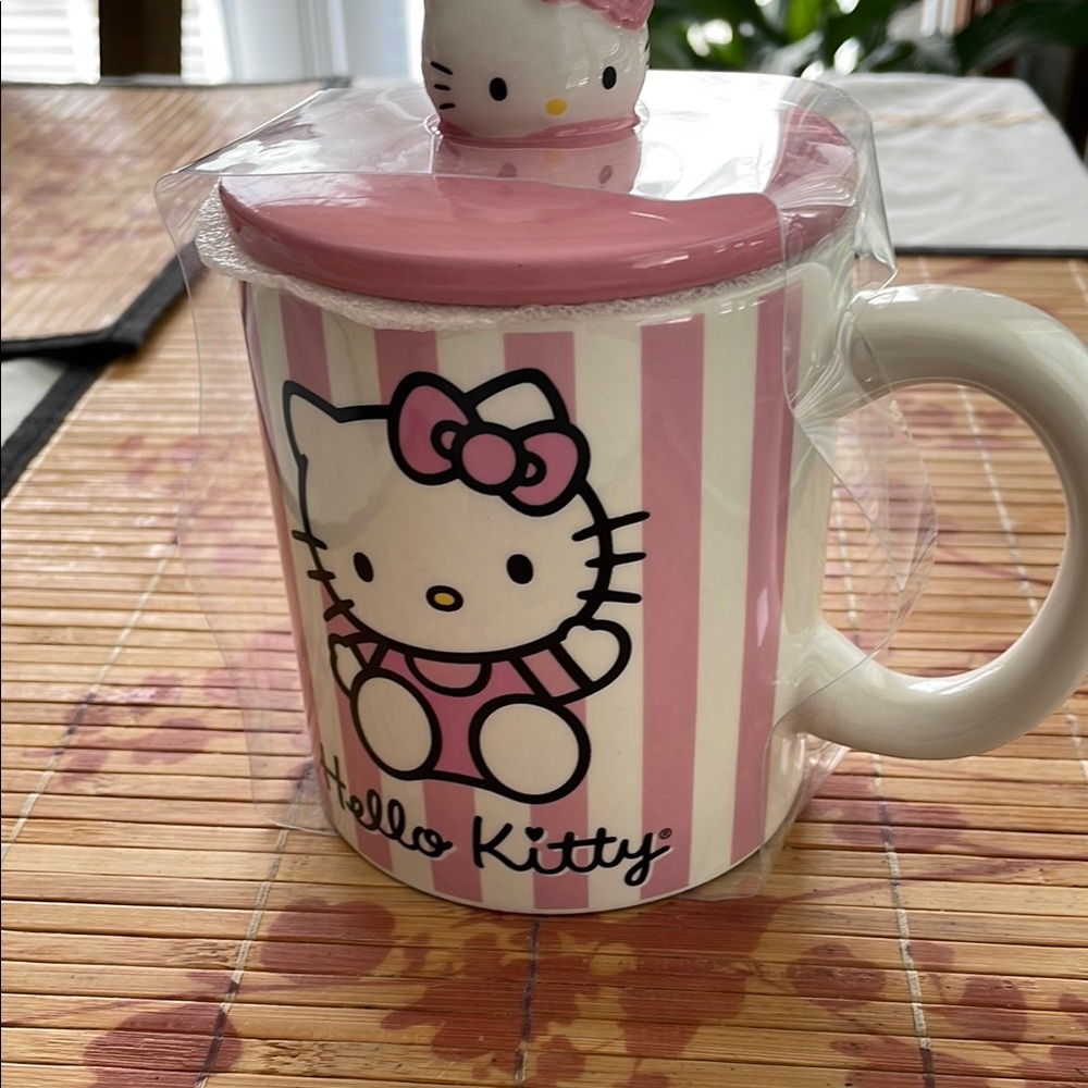 Sanrio Hello Kitty Pink and White Striped Mug with lid .